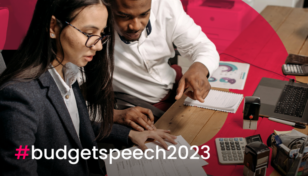 Two people analysing business documents with the hashtag budget speech 2023