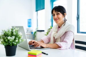 A business owner smiling while applying for a working capital loan online in 3 easy steps.