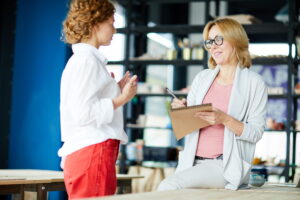 A business advisor explaining how small business loans work to a small business owner in a studio.