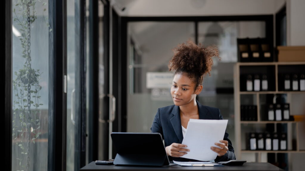 A small business owner carefully reviewing factors to consider before applying for a small business loan