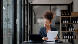 A small business owner carefully reviewing factors to consider before applying for a small business loan
