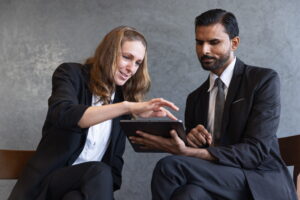 A business advisor and client reviewing financing options on a tablet.