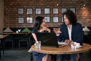 two colleagues discussing how to manage small business loans effectively