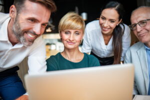 collogues looking at a laptop with business loan options